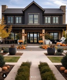 a large house with lots of pumpkins in the front yard