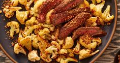 steak and cauliflower on a plate with seasoning