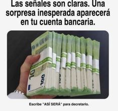 a person holding stacks of money in front of an advert for the spanish government