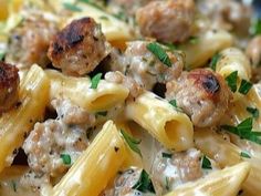 pasta with meatballs and parsley in a white sauce