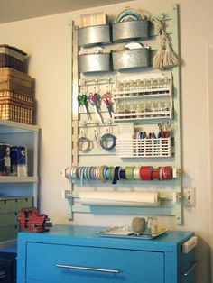 there is a blue cabinet in the room with many items on it and hanging from the wall