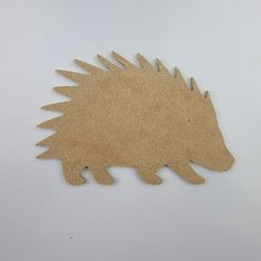 a wooden hedgehog cutout on a white background