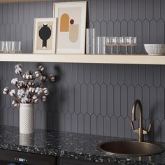 a vase with flowers on top of a counter next to a sink and shelf filled with glasses