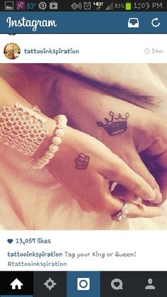 two people holding hands with tattoos on their fingers and one has a crown tattooed on the wrist