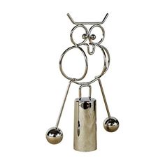 a metal object with three balls and two poles on it's head, in the shape of an owl