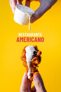 a person is dipping sauce on some food in front of the words restaurante americano