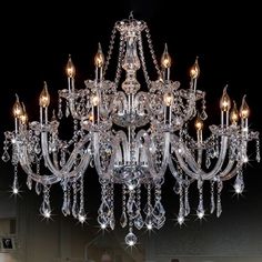 a crystal chandelier hanging from the ceiling in a living room