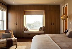 an image of a bedroom with brown furniture and window sill in the middle,