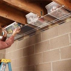 a man is working on the ceiling in his house