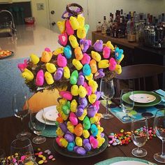 the table is set with colorful candy and wine glasses