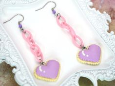 Pride Month Sale! Discount: 20% off when you buy 2 items + free pride themed jewelry gift! Promo code: HAPPYPRIDEMONTH Radiate kawaii charm with these adorable Pixel Heart Cookie Dangle Earrings, inspired by the vibrant and playful aesthetics of Harajuku and Decora Kei styles in Japanese fashion. These earrings are a delightful fusion of cuteness and creativity, perfect for those who love to make a sweet statement. Crafted with attention to detail, each earring features a colorful pixelated heart-shaped cookie that dangles elegantly, adding a touch of whimsy to any outfit. Embrace your inner style icon and add a fun twist to your look with these unique accessories that capture the essence of Harajuku fashion. Elevate your accessory game with these Pixel Heart Cookie Dangle Earrings and let Cute Dangle Earrings With Heart Charm, Cute Nickel Free Heart Drop Earrings, Cute Heart Dangle Earrings With Ear Wire, Cute Dangle Heart Earrings With Ear Wire, Kawaii Heart-shaped Earrings For Valentine's Day, Kawaii Heart Earrings For Valentine's Day, Kawaii Dangle Jewelry For Valentine's Day, Cute Dangle Heart Earrings, Cute Pink Pierced Heart Earrings