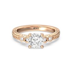 a rose gold engagement ring with an oval cut diamond in the center and side stones