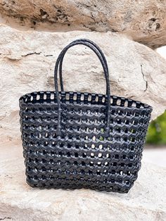 Wear to your next sunny-day event with this cute basket tote! Top Handle to Bottom - 14"H x 12"L Eco-friendly Straw Bag For Shopping With Top Carry Handle, Shopping Beach Bag With Braided Top Handles, Shopping Beach Bag With Top Handle And Braided Handles, Top Handle Beach Bag With Braided Handles For Shopping, Black Summer Bucket Bag For Shopping, Summer Shopping Bucket Bag With Top Carry Handle, Trendy Bucket Beach Bag With Top Carry Handle, Summer Black Bucket Bag For Shopping, Daily Use Straw Bucket Bag With Top Handle