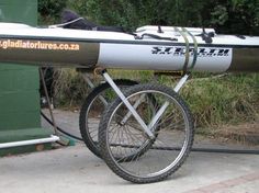 a white and black bike parked next to a green building