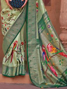 Give yourself a simple but significant look with this adorable light green paithani printed poly silk saree beautified with floral peacock motifs and highlighted with foil print and lovely tassels. This beautiful green paithani saree comes with a dark green color blouse festooned with a foil print. This stunning paithani green saree is 5.50 meters long and comes with fully unstitched 0.80 meters blouse material. Rock the party with this light green paithani printed silk saree and drape the flawl Green Saree With Motifs For Festivals, Green Paithani Silk Dupatta With Motifs, Green Paithani Silk Saree For Festivals, Green Saree With Printed Border For Eid, Festival Green Paithani Silk Saree, Green Traditional Wear With Printed Border In Art Silk, Green Saree With Printed Border For Diwali, Diwali Green Saree With Printed Border, Traditional Light Green Dupatta For Festivals