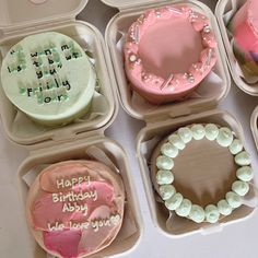 there are many different types of birthday cakes in the trays on the table together