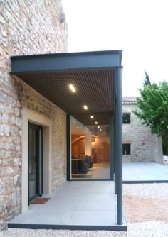 an open patio with sliding glass doors and stone walls