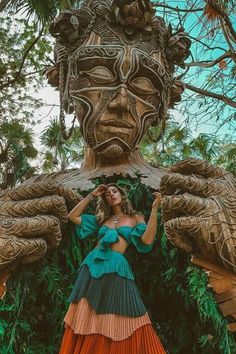 a woman is standing in front of a statue