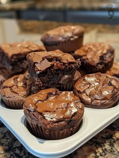 some chocolate cupcakes are on a white plate