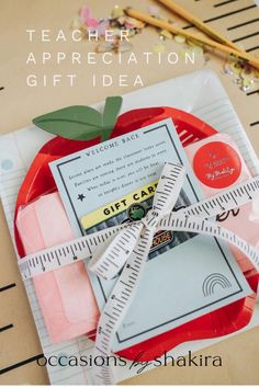 a teacher appreciation gift idea with an apple and measuring tape on top of the plate