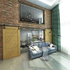 a living room filled with furniture next to a brick wall and wooden sliding barn doors