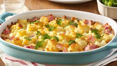 a casserole dish with ham and cheese in it on a table next to other dishes