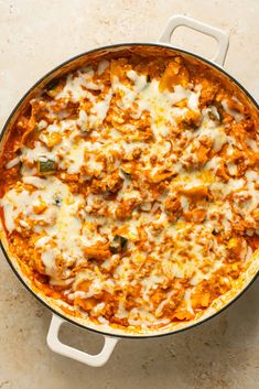 a casserole dish with meat and cheese in it on a counter top, ready to be eaten