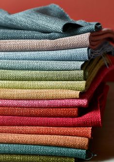 a stack of folded towels sitting on top of a table