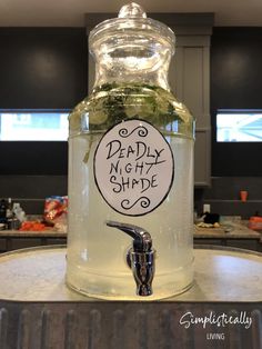 a glass jar filled with liquid sitting on top of a counter