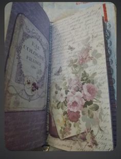 an open book with flowers and writing on it