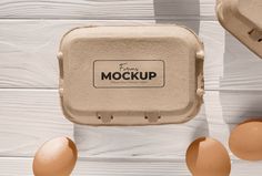 two eggs and an egg carton with the word mockup written on it