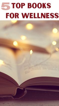 an open book on top of a table with lights in the background and text overlay that reads, 5 top books for wellness