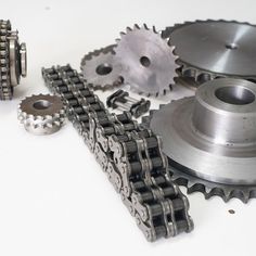 several different types of gears and chains on a white surface