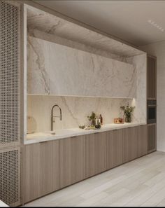 an image of a kitchen setting with white marble counter tops and wooden cabinets on the wall