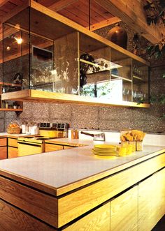 a large kitchen with wooden cabinets and counter tops, along with an island in the middle