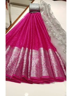 a pink and white saree with silver thread work on the palan silks