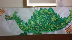 an art project made out of paper with green and yellow designs on the front, along with american flags