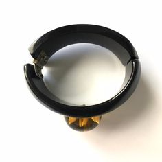 "Item: This is a fabulous black bakelite clamper bangle bracelet with a reverse carved apple juice flower cabochon mounted in the center. It's in excellent condition, has been tested and guaranteed vintage bakelite. Be sure to check our other listings for lots more bakelite jewelry! Measurements: 1 1/4\" wide in front - 2 1/4\" inner oval diameter, 6 3/8\" inner circumference. Condition: 9.5 - Excellent Shipping: US buyers pay $14.95 for Fully Insured USPS Priority Mail with Tracking. Internatio Vintage Bakelite Bracelet, Vintage Bakelite Bangle Jewelry, Vintage Bakelite Bangle, Vintage Lucite Bangle Bracelet, Vintage Black Bangle Cuff Bracelet, Vintage Black Bangle, Juice Flower, Jewelry Measurements, Bakelite Jewelry