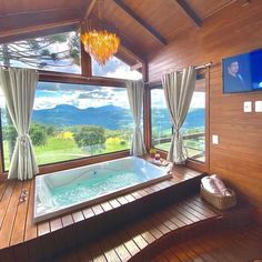 a large jacuzzi tub sitting inside of a wooden room