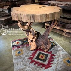 a table made out of tree trunks on top of a rug