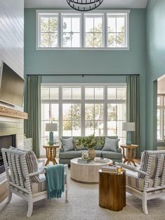 a living room filled with furniture and windows