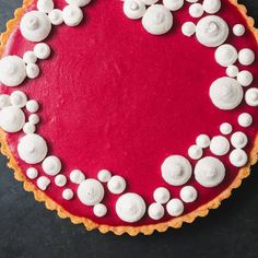 a red cake with white icing on it