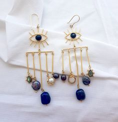 Chunky Evil Eye Long Statement Dangle Earrings, Chandelier Lapis Earrings, Boho Style Gold Brass Earrings  Why these earrings can be a perfect gift for your loved one or you? - Comes in great packaging, with a re usable storage box & a silk pouch.  - Perfect for all occasions. - You can add a personal message to your order.  To make your purchase a special gift for your friend or family, you can choose from our pre made relationship cards.  PLEASE SELECT THE RELATIONSHIP CARD WHILE CHECKING OUT. FOR REFERENCE GO THROUGH THE LAST IMAGE OF THE LISTING.  Specifications -  Gemstone  - Natural Lapis, Labradorite, Pearl  Length  - 4 inches approx  Find the best pair of earrings for your beautiful ears here -  https://www.etsy.com/shop/TheEnache?ref=seller-platform-mcnav&section_id=28306680 ** IM Bohemian Dangle Earrings For Party, Bohemian Dangle Chandelier Earrings For Parties, Bohemian Chandelier Dangle Earrings For Parties, Bohemian Party Chandelier Dangle Earrings, Bohemian Chandelier Earrings With Dangling Beads For Party, Bohemian Teardrop Chandelier Earrings For Party, Bohemian Chandelier Earrings For Party, Bohemian Long Drop Chandelier Earrings For Parties, Brass Chandelier Earrings With Dangling Beads As Gift