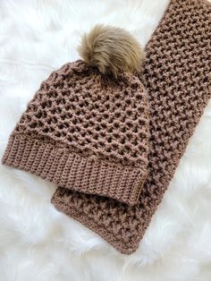 two crocheted beanies with a pom - pom on top