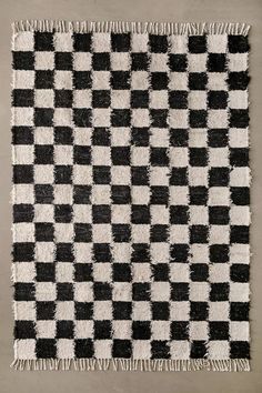 a black and white checkered rug with fringes