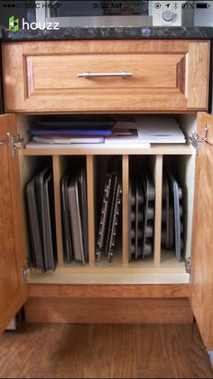 an open cabinet with many files and folders in it