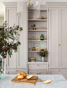 the kitchen is clean and ready to be used for cooking or baking, with white cabinets and marble countertops