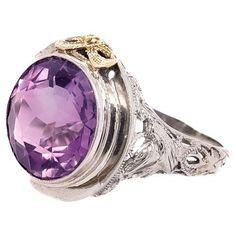 A fine antique Art Deco ring. In 18k white and yellow gold. By the Art Deco period jewelers Baskin Bros. of New York, New York. Bezel set with a large round-cut amethyst to its center. The ornate white gold filigree setting has flower and leaf work throughout as well as two "lovebirds" to its shoulders and a yellow gold bow to the front of the setting. Simply wonderful Art Deco design! Date: Early 20th Century Overall Condition: It is in overall good, as-pictured, used estate condition. Conditio Pink Topaz Ring, Gold Amethyst Ring, 1950 Vintage, Precious Gemstones Jewelry, Three Graces, Floral Ring, Gold Engraving, Estilo Art Deco, Amethyst Bracelet