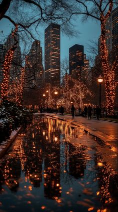 the city is lit up with christmas lights and reflecting in the water at night time