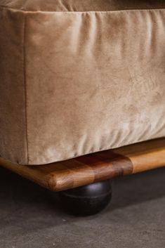 a close up view of a footstool with a pillow on it's back